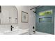 Modern bathroom featuring a herringbone tile accent wall, sleek fixtures, and ample counter space at 6405 Cherry Tree Ln, Atlanta, GA 30328