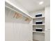 Organized walk-in closet with built-in shelving and hanging rods for clothing storage at 6405 Cherry Tree Ln, Atlanta, GA 30328