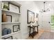 Inviting entryway with built-in shelves, wood table, decorative mirror, and modern chandelier at 6405 Cherry Tree Ln, Atlanta, GA 30328