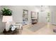 Bright entryway featuring light wood floors, white walls, built-in shelving, and stylish decor at 6405 Cherry Tree Ln, Atlanta, GA 30328