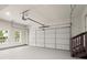 Spacious two-car garage with stairs, painted floor, and ample room for parking and storage at 6405 Cherry Tree Ln, Atlanta, GA 30328