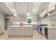 Bright kitchen featuring custom cabinets, a large island, stainless appliances, and modern pendant lighting at 6405 Cherry Tree Ln, Atlanta, GA 30328