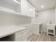 Bright laundry room with white cabinets, countertops, and a utility sink at 6405 Cherry Tree Ln, Atlanta, GA 30328