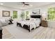 Comfortable main bedroom with multiple windows, a ceiling fan, and neutral decor at 6405 Cherry Tree Ln, Atlanta, GA 30328