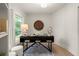 Cozy office space with a large window, modern desk, and wood-paneled accent wall at 6405 Cherry Tree Ln, Atlanta, GA 30328