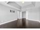 Main bedroom featuring dark wood floors, tray ceiling, neutral walls and multiple windows at 1264 Ridge Vista Nw Ct, Lawrenceville, GA 30043