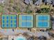 Aerial view of three tennis courts with blue and green surfaces, next to a swimming pool at 1264 Ridge Vista Nw Ct, Lawrenceville, GA 30043