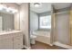 Bathroom with a tub, shower, and dual sink vanity with neutral paint tones at 1321 Stoneleigh Dr, Conyers, GA 30094