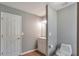 View of half bath with vanity, toilet and door at 1321 Stoneleigh Dr, Conyers, GA 30094
