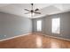 Bright bedroom with hardwood floors, ceiling fan, and natural light from two windows at 1321 Stoneleigh Dr, Conyers, GA 30094