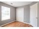 Bedroom with a closet, window, wood floors, and painted in neutral tones at 1321 Stoneleigh Dr, Conyers, GA 30094