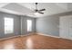 Spacious bedroom with tray ceiling, ceiling fan and two windows letting in natural light at 1321 Stoneleigh Dr, Conyers, GA 30094