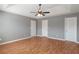 Bedroom featuring three closets, tray ceiling and fan, painted in stylish neutral colors at 1321 Stoneleigh Dr, Conyers, GA 30094