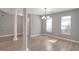 Bright dining area featuring hard floors, a chandelier, and large windows at 1321 Stoneleigh Dr, Conyers, GA 30094