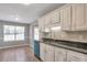 Kitchen featuring white cabinets, granite countertops, and updated stainless-steel appliances at 1321 Stoneleigh Dr, Conyers, GA 30094