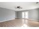 Bright living room with wood floors, gray walls, and French doors to a yard at 1321 Stoneleigh Dr, Conyers, GA 30094