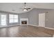 Spacious living room with a fireplace, modern floors, and ample natural light at 1321 Stoneleigh Dr, Conyers, GA 30094