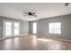Open living room with natural light, grey walls, and a door leading to the outside at 1321 Stoneleigh Dr, Conyers, GA 30094