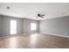 Open-plan living room with light gray walls, hardwood floors, and lots of natural light at 1321 Stoneleigh Dr, Conyers, GA 30094