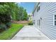 Spacious backyard featuring a concrete patio, lush greenery, and a well-maintained lawn at 2848 Stockbridge Way, Dacula, GA 30019