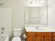 Bathroom featuring a vanity with a sink and a toilet and shower/bath to the left at 2848 Stockbridge Way, Dacula, GA 30019