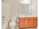 Well-lit bathroom with a single sink vanity, toilet, and shower over tub at 2848 Stockbridge Way, Dacula, GA 30019