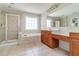 Bathroom with soaking tub, walk-in shower, vanity with storage, and neutral tiled floors at 2848 Stockbridge Way, Dacula, GA 30019