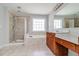Bathroom features a walk-in shower, soaking tub, vanity with storage, and neutral tiled floors at 2848 Stockbridge Way, Dacula, GA 30019