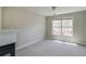Cozy bedroom with a fireplace, neutral walls, carpet and a large sunny window at 2848 Stockbridge Way, Dacula, GA 30019