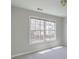 Bright bedroom featuring a large window offering ample natural light and neutral wall color at 2848 Stockbridge Way, Dacula, GA 30019