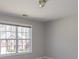 Bright bedroom featuring a large window offering ample natural light and neutral wall color at 2848 Stockbridge Way, Dacula, GA 30019