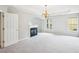 Large main bedroom featuring neutral carpeting, a fireplace, and large windows for natural light at 2848 Stockbridge Way, Dacula, GA 30019