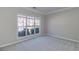 Cozy bedroom with neutral carpet and large windows offering natural light at 2848 Stockbridge Way, Dacula, GA 30019
