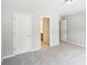 Bedroom with neutral color walls and view of bathroom through the opened door at 2848 Stockbridge Way, Dacula, GA 30019