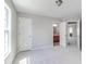 Bedroom featuring neutral walls and carpet, with doorways to the ensuite bathroom and hall at 2848 Stockbridge Way, Dacula, GA 30019