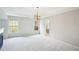 Main bedroom with a tray ceiling, fireplace, and a doorway into an en suite bathroom at 2848 Stockbridge Way, Dacula, GA 30019