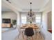 Bright dining room with modern chandelier, tray ceiling, and large windows at 2848 Stockbridge Way, Dacula, GA 30019