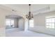 Open dining room with decorative lighting, wainscoting, and lots of natural light at 2848 Stockbridge Way, Dacula, GA 30019