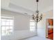 Dining room features tray ceiling, decorative chandelier, and wainscoting at 2848 Stockbridge Way, Dacula, GA 30019