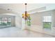 Open dining area with decorative lighting, chair rail, and large windows providing ample natural light at 2848 Stockbridge Way, Dacula, GA 30019