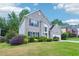 Beautifully landscaped front yard of a two-story house with a brick exterior, well-maintained lawn, and colorful bushes at 2848 Stockbridge Way, Dacula, GA 30019