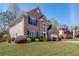 Side view of a well-maintained two-story home with lush greenery and a blue sky backdrop at 2848 Stockbridge Way, Dacula, GA 30019