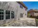 The home's exterior, featuring a concrete patio and lush greenery and a well maintained lawn at 2848 Stockbridge Way, Dacula, GA 30019