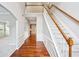 Inviting foyer with hardwood floors, staircase, and white trim, leading to carpeted living spaces and arched doorways at 2848 Stockbridge Way, Dacula, GA 30019
