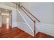 Elegant foyer featuring a staircase with wooden handrail and white trim accents at 2848 Stockbridge Way, Dacula, GA 30019