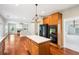 View of kitchen with an island, adjacent to a living room and dining area. Features updated appliances at 2848 Stockbridge Way, Dacula, GA 30019