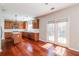 Well-lit kitchen with wood cabinets, stainless steel appliances, an island, and sliding glass doors at 2848 Stockbridge Way, Dacula, GA 30019