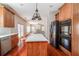 Well-lit kitchen showcasing stainless appliances, a central island, and a view into the living room at 2848 Stockbridge Way, Dacula, GA 30019