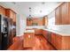 Modern kitchen with wood cabinets, stainless steel appliances, a central island, and ample counter space at 2848 Stockbridge Way, Dacula, GA 30019