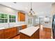 Open kitchen view with an island, stainless steel appliances, lots of counter space and natural light at 2848 Stockbridge Way, Dacula, GA 30019